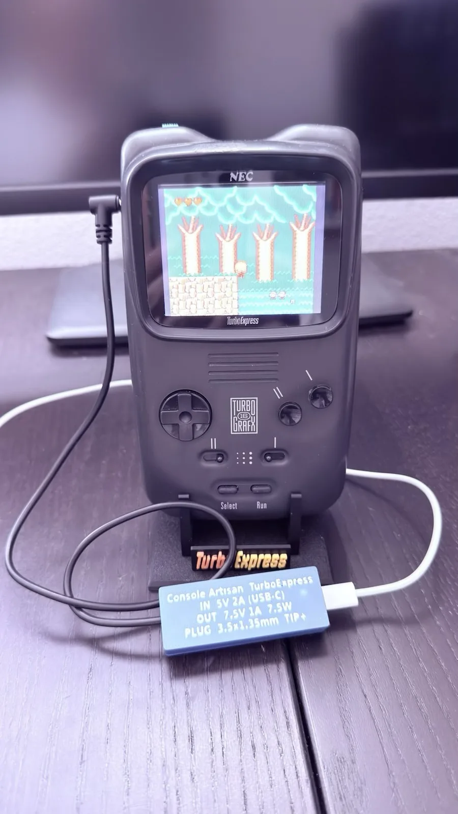 A customer's NEC TurboExpress running a game, powered by the TurboExpress adapter