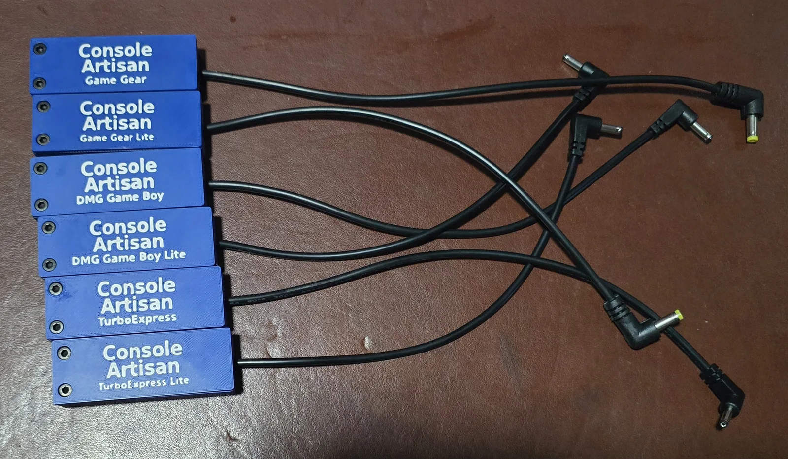 The full Console Artisan dongle lineup: Game Gear, DMG Game Boy, and TurboExpress adapters in standard and Lite versions