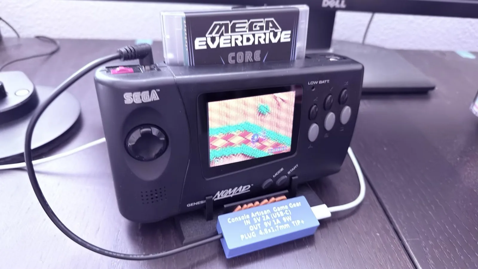 A customer's Sega Nomad running Sonic with a Mega Everdrive, powered by the same Game Gear adapter
