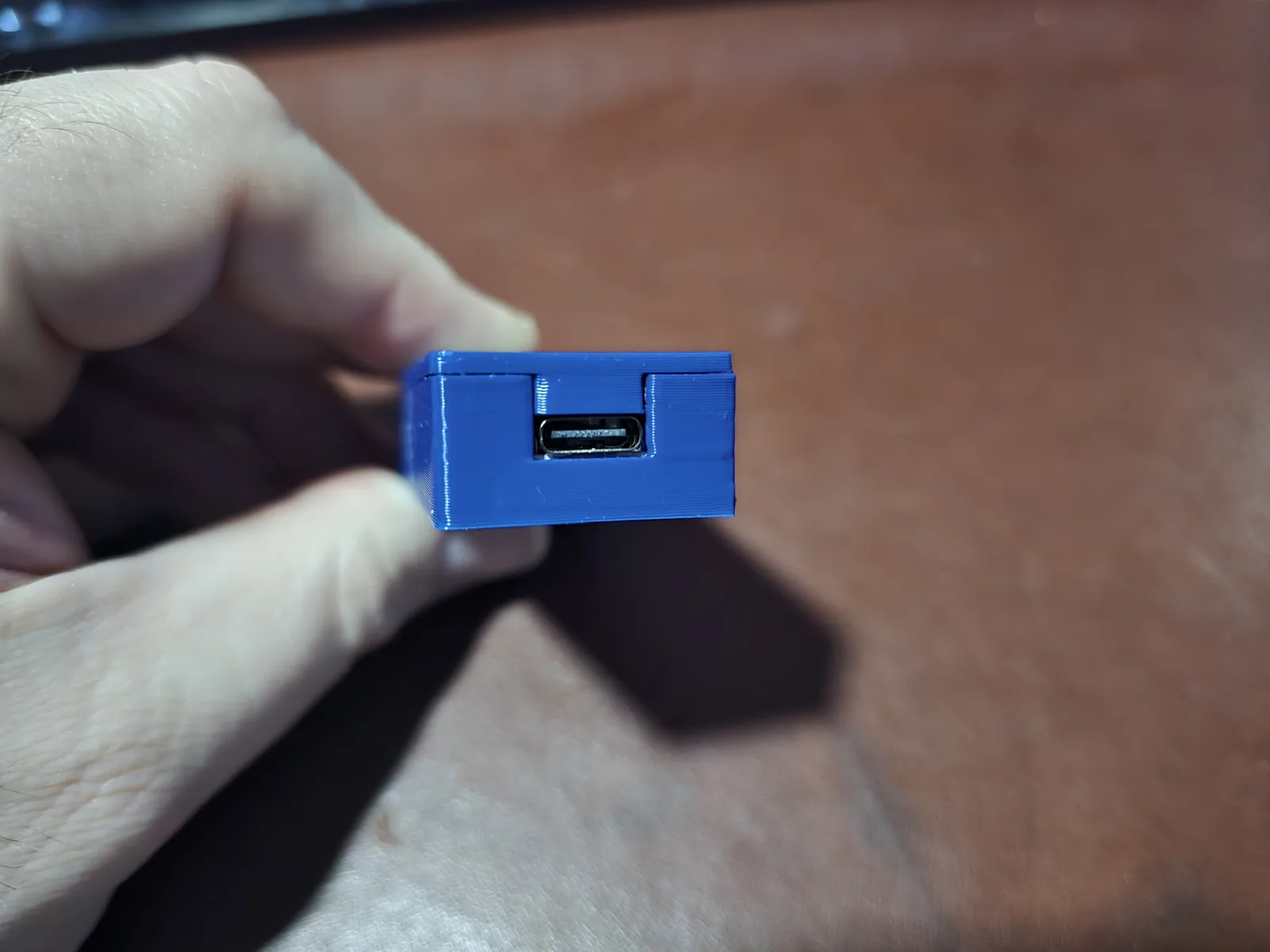 The USB-C input end of the adapter's 3D-printed case