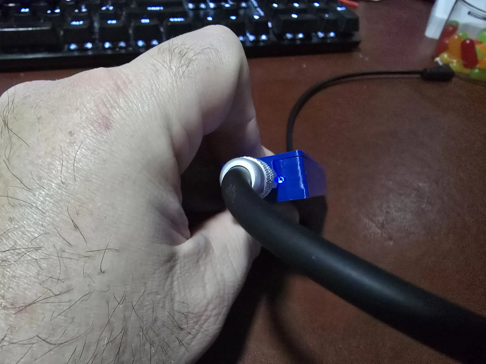 The Lite adapter plugged in with its blue power LED lit
