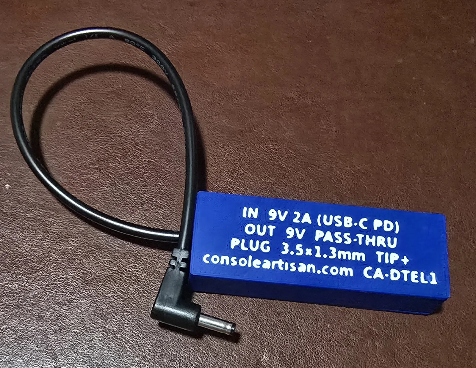 Back label of the TurboExpress Lite adapter reading IN 9V 2A USB-C PD, OUT 9V pass-through, plug 3.5x1.35mm tip-positive, model CA-DTEL1