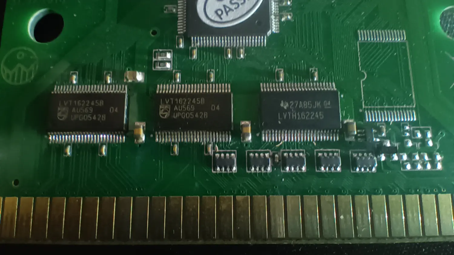 Close-up of a Mega EverDrive X3 PCB above the card edge connector, showing the same three transceivers as the X5, two marked LVT162245B and one marked LVTH162245, above a row of small SOIC-8 packages.