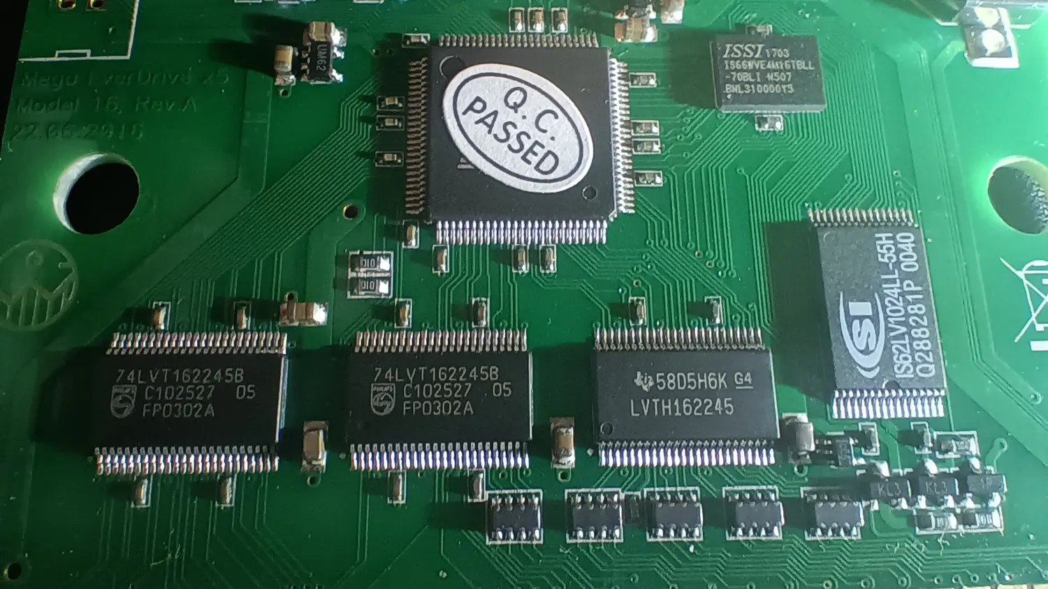 Close-up of a Mega EverDrive X5 PCB above the card edge connector, showing two 48-pin transceivers marked LVT162245B AU569 UPG05428 and a third marked 27AB5JK G4 LVTH162245, with an ISSI SRAM to the right.