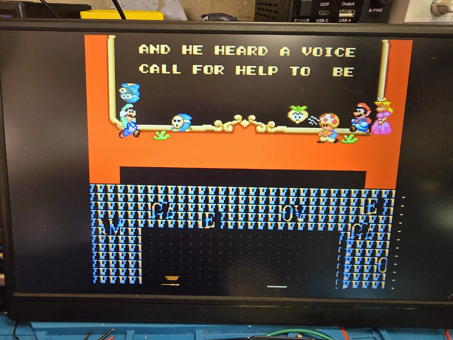 A CRT-style display showing Super Mario All-Stars running Super Mario Bros 2. The upper half of the screen renders correctly with the story text AND HE HEARD A VOICE CALL FOR HELP TO BE and the character sprites intact, while the lower half of the screen is filled with repeated garbage tiles in blue and yellow forming dense meaningless rows.